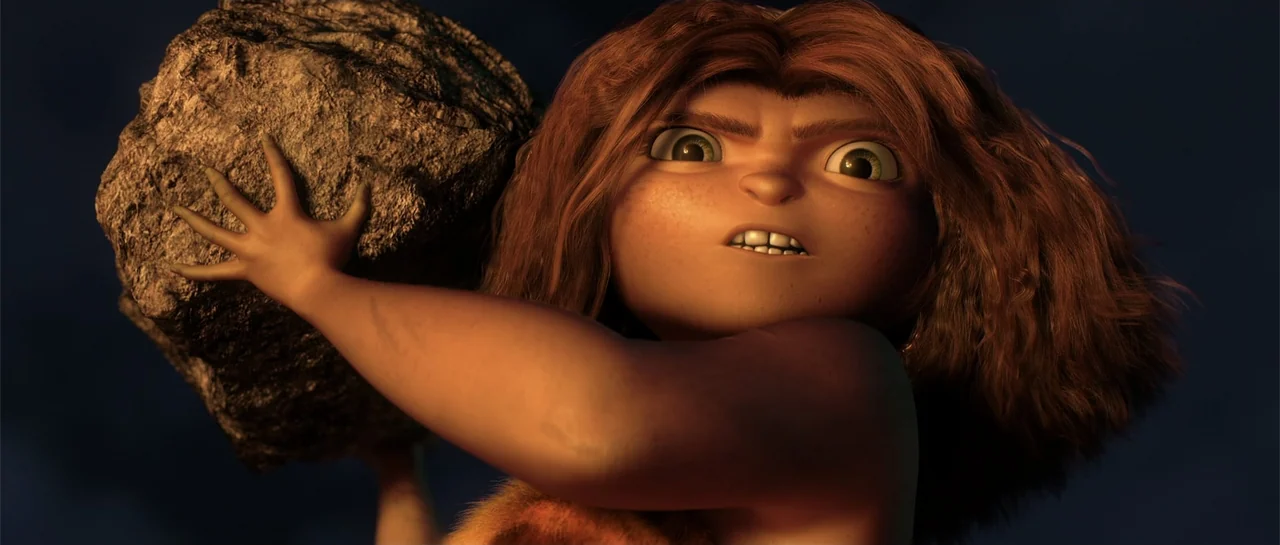 The Croods (2013) movie still: closeup — A dark outdoor space at night with a large rock held by a child. A young girl with wild hair holds a…