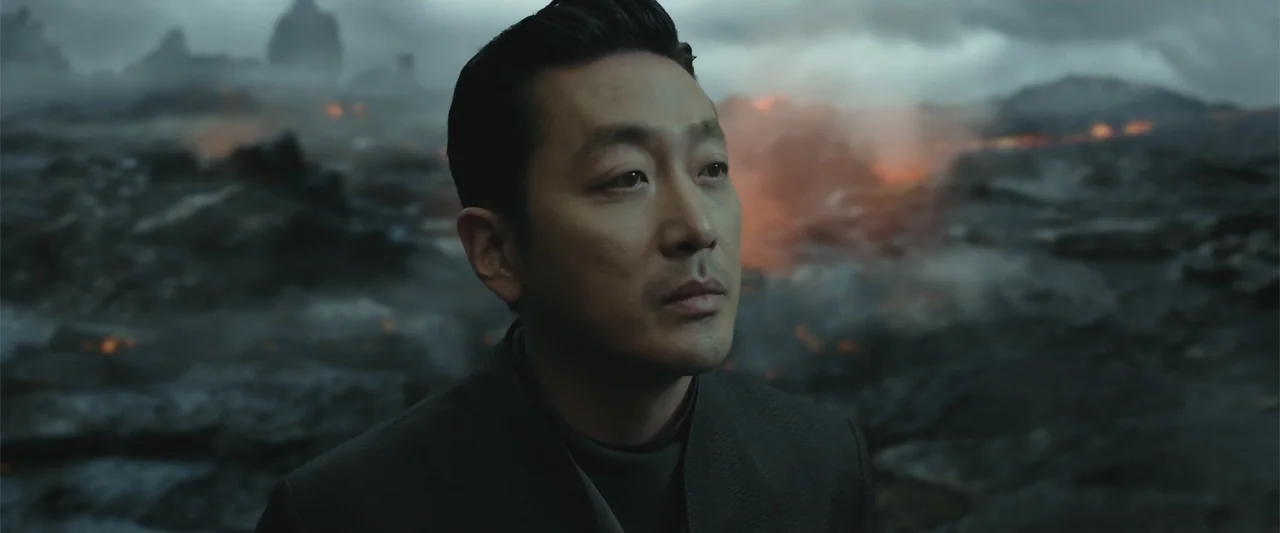 Along with the Gods: The Two Worlds (2017) movie still: medium — A desolate volcanic field with jagged dark rock and glowing lava embers at night. A…