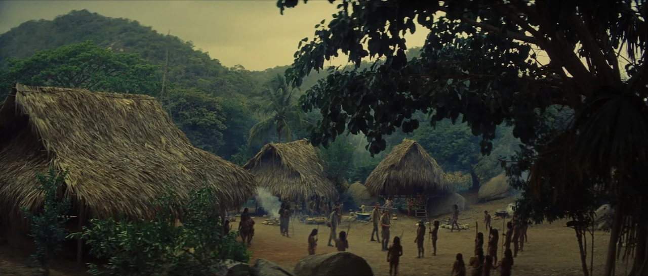 The Lost City of Z (2016) movie still: wide — A remote village features several thatched-roof huts constructed of dried palm leaves and wood.…