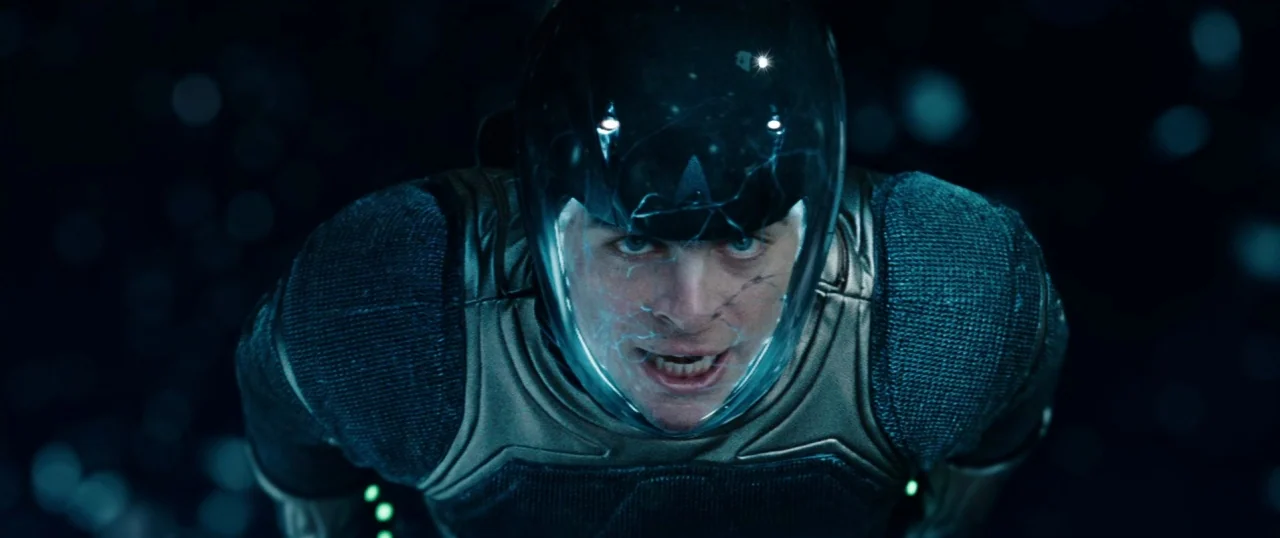 Star Trek Into Darkness (2013) movie still: closeup — A man drifts through a dark void filled with scattered specks of reflected light. He wears a…