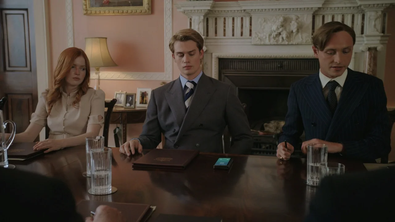 Red, White & Royal Blue (2023) movie still: medium — An elegant wood-paneled room features a fireplace and framed pictures on the wall. Three people…