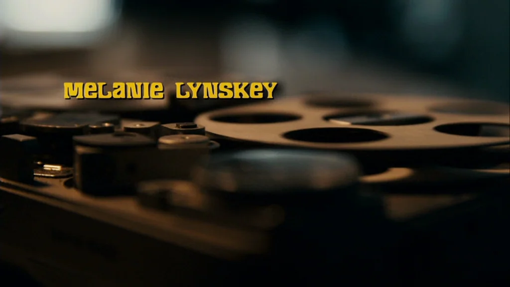 The Informant! (2009) movie still: closeup — A close-up view of a reel-to-reel magnetic tape machine mechanism. The device is dark and metallic,…