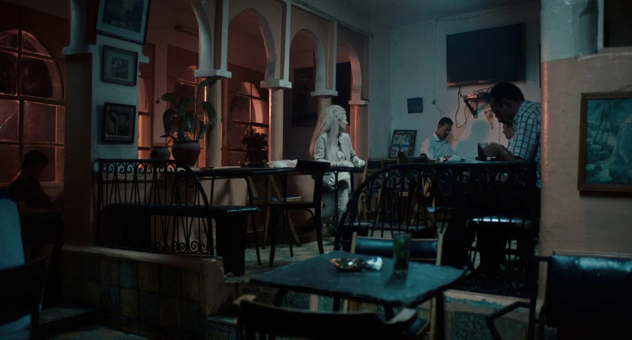 Only Lovers Left Alive (2013) movie still: wide — A dimly lit cafe interior features decorative arched columns and dated tiled wall accents. Patrons…