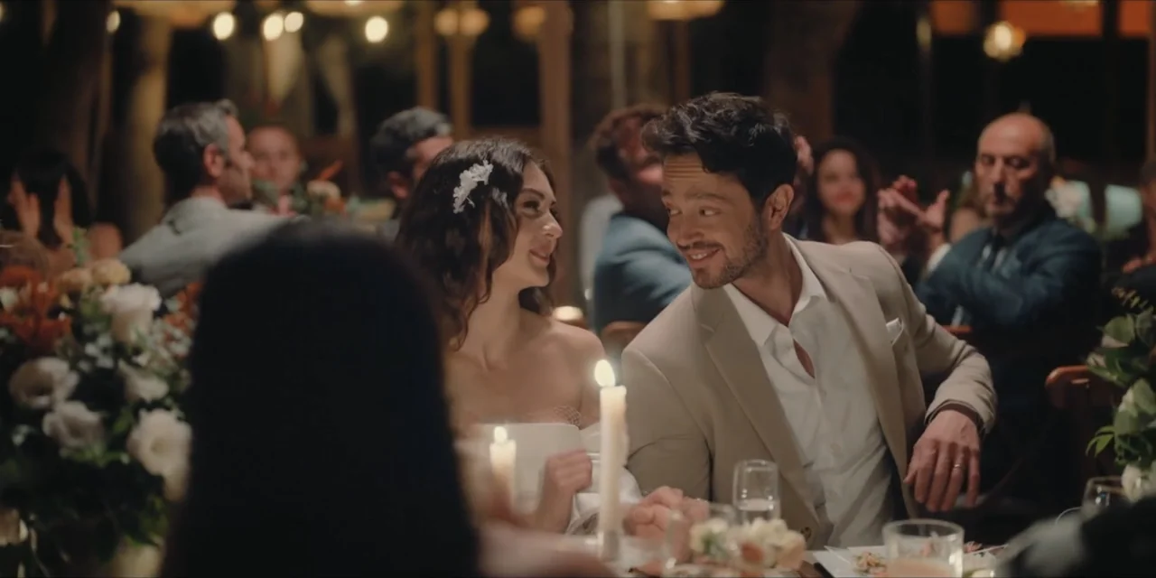 Kill Me If You Dare (2019) movie still: medium — An outdoor wedding reception is decorated with candles and flowers at night. A bride and groom look…