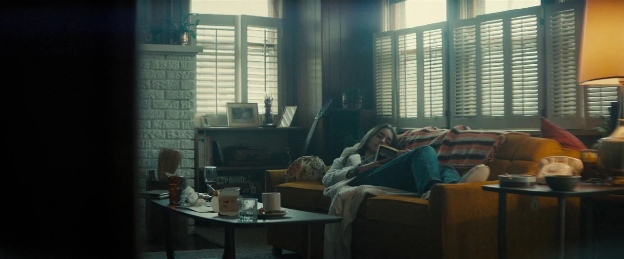 Extremely Wicked, Shockingly Evil and Vile (2019) movie still: wide — A living room interior features wood-paneled walls and a brick fireplace…