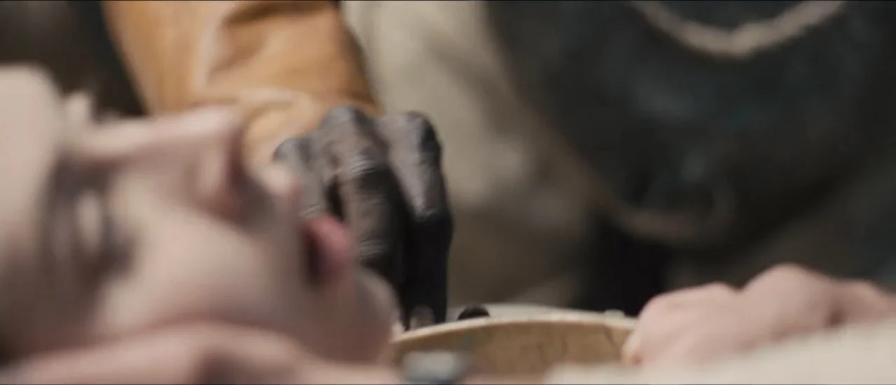 Fear Below (2025) movie still: closeup — A close-up view of a person lying down with another person reaching out. A dark-skinned hand rests on the…