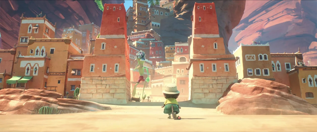 Around the World in 80 Days (2021) movie still: wide — A desert town features tiered adobe structures with reddish walls nestled against a canyon. A…