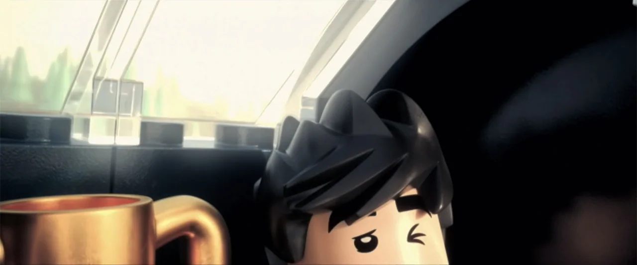 Piece by Piece (2024) movie still: closeup — A plastic minifigure sits inside a vehicle near a window. The character looks outward with narrowed eyes.