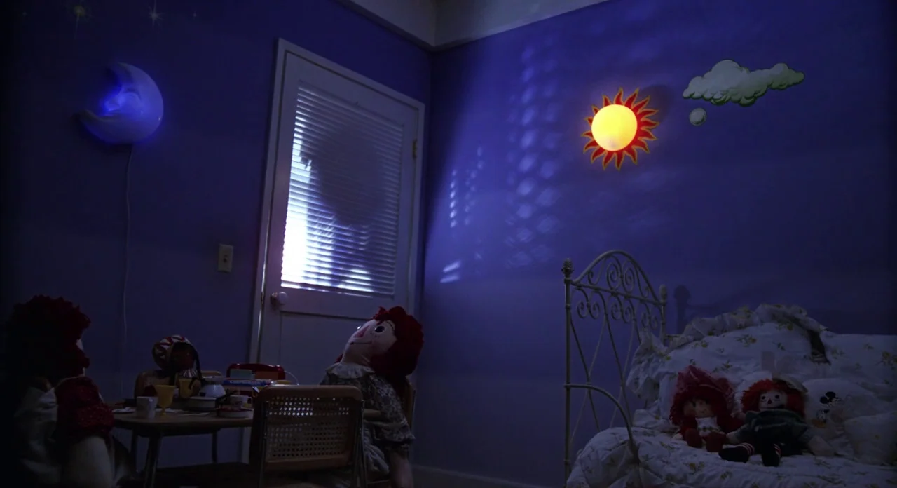 E.T. The Extra-Terrestrial (1982) movie still: wide — A dark child's room features purple walls decorated with a wall-mounted moon and sun. A…