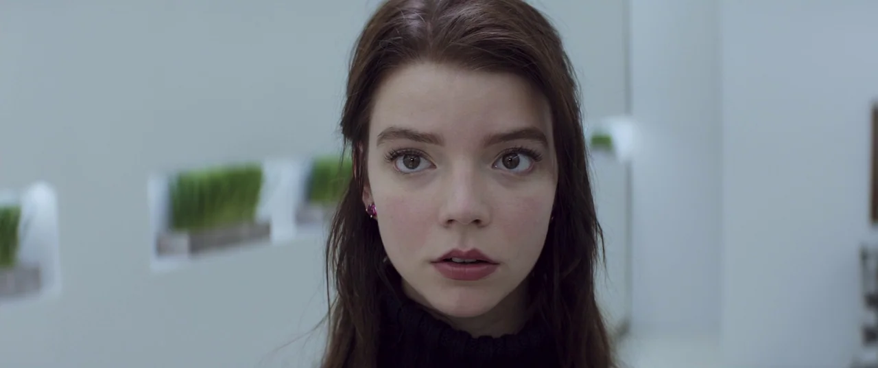 Thoroughbreds (2017) movie still: closeup — A sterile white minimalist corridor features small alcoves with green grass plants. A young woman looks…