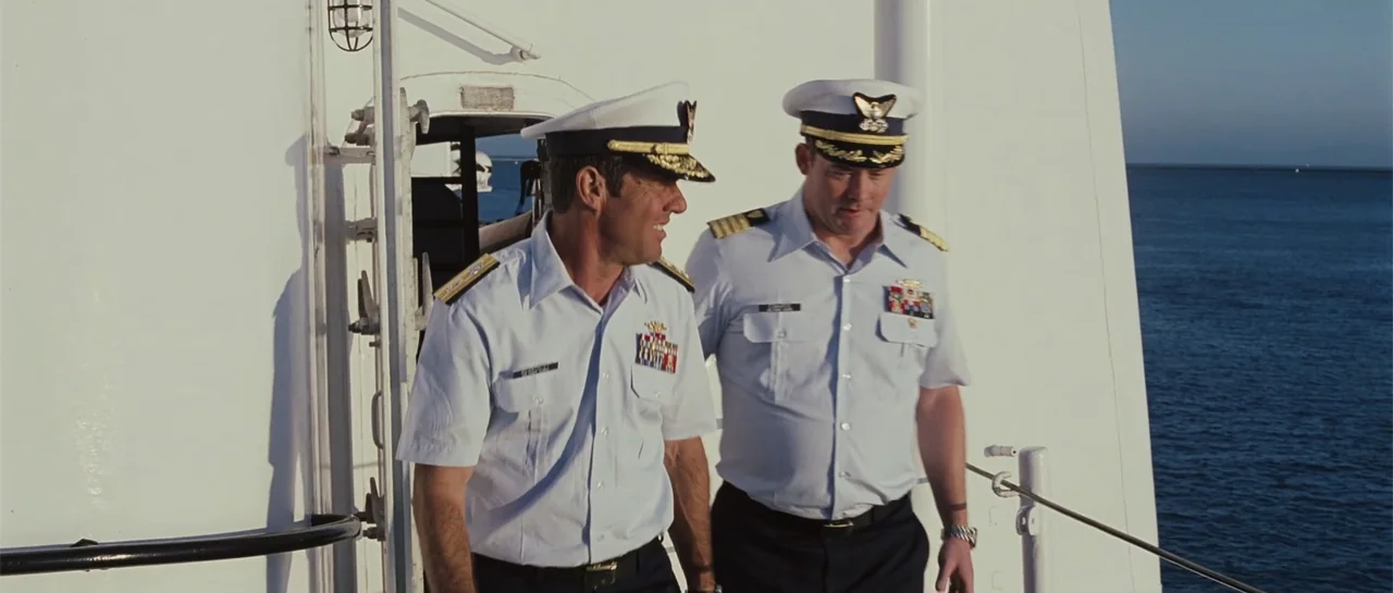 Yours, Mine & Ours (2005) movie still: medium — Two naval officers walk across the white sunlit deck of a large vessel. The men are wearing crisp…