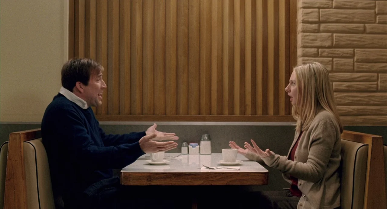 The Weather Man (2005) movie still: medium — A diner booth features a formica table against a vertical wooden slat wall. A man and a woman sit…