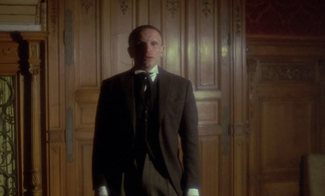 The Strange Case of Dr. Jekyll and Miss Osbourne (1981) movie still: medium — A dimly lit room with tall, ornate wooden paneling covering the walls.…