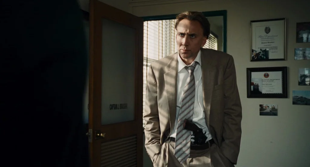 Bad Lieutenant: Port Of Call New Orleans (2009) movie still: medium — An interior office space features light-colored walls adorned with framed…