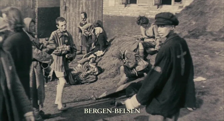 The Last Days (1998) movie still: wide — An outdoor area at the Bergen-Belsen concentration camp features muddy ground and brick structures.…