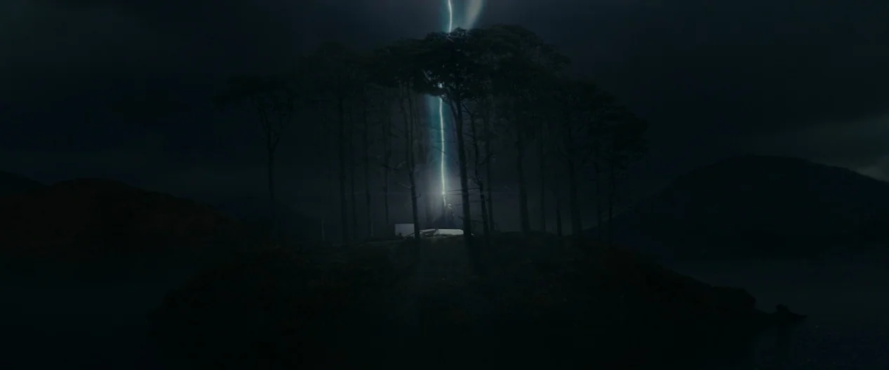 Harry Potter & The Deathly Hallows Part 1 (2010) movie still: establishing — A dark, silhouetted island sits in the middle of a calm body of water.…