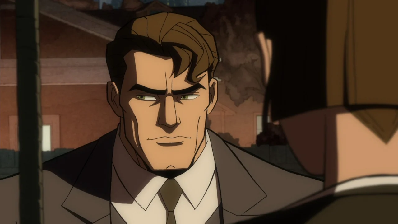 Batman: The Long Halloween, Part One (2021) movie still: medium — A man in a suit stands outside at dusk in front of a house. He looks toward an…
