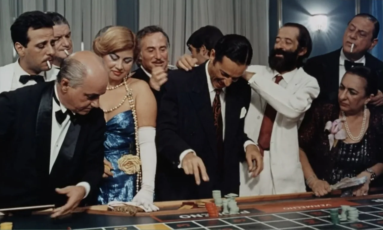 Dona Flor and Her Two Husbands (1976) movie still: medium — A crowded gaming table in a brightly lit room with formal attire present. Guests gather…