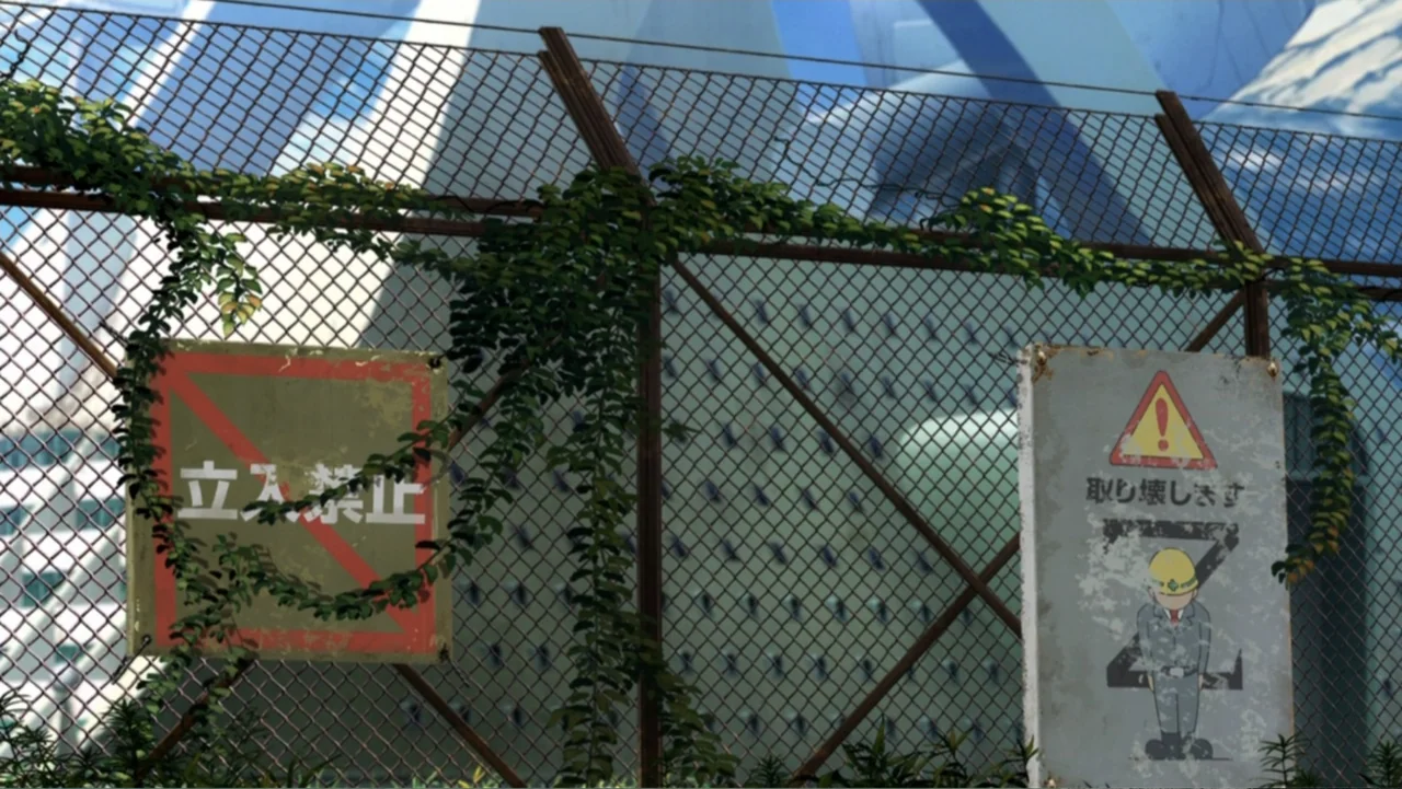 Mazinger Z: Infinity (2017) movie still: wide — A metal chain-link fence covered in crawling vines separates the foreground from large buildings.…