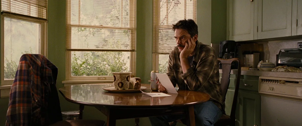 The Twilight Saga: Breaking Dawn – Part 1 (2011) movie still: medium — A residential room featuring light green cabinets and a wooden circular…