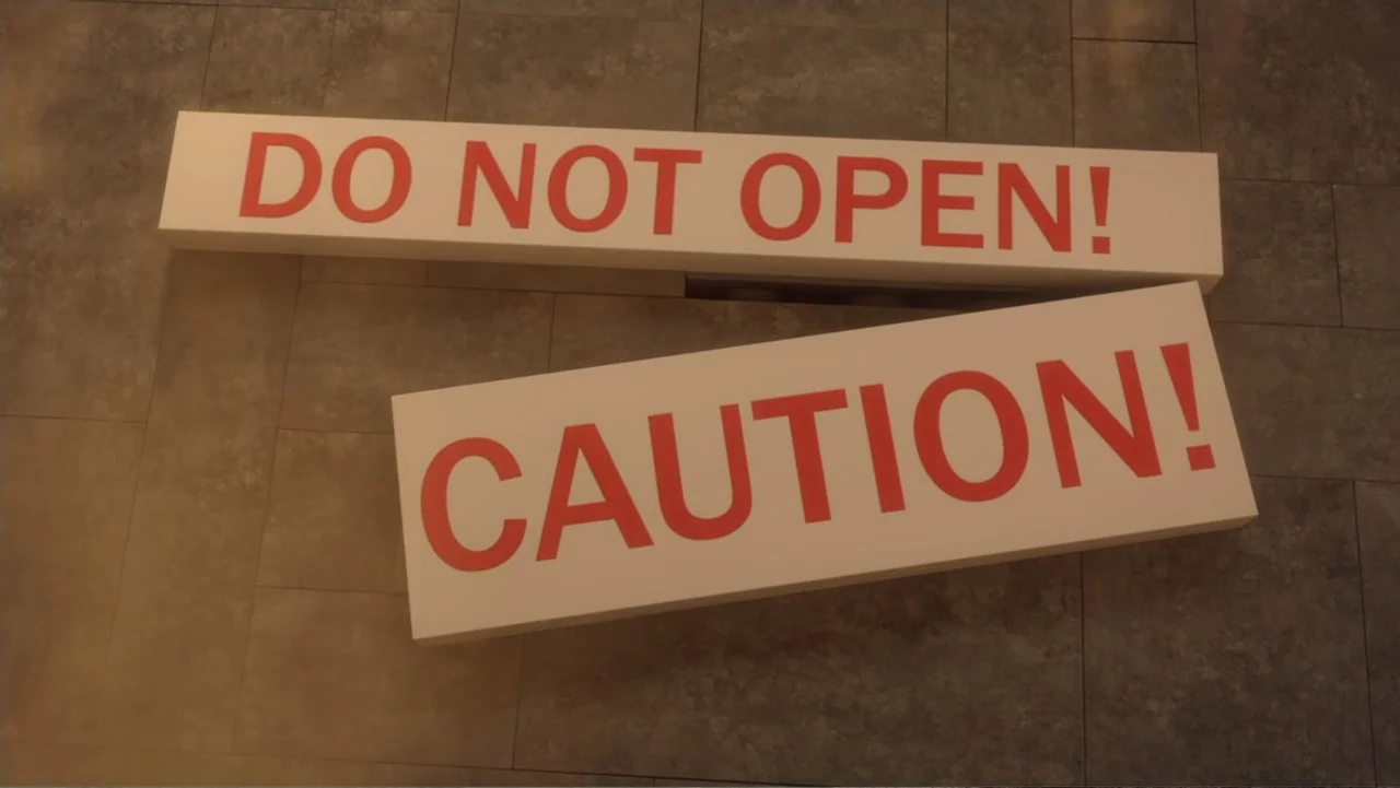 LEGO DC: Shazam! Magic and Monsters (2020) movie still: closeup — Two rectangular white placards are placed on a grey tiled surface. One placard…