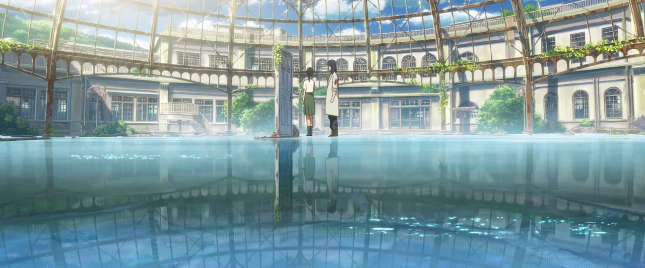 Suzume (2022) movie still: wide — A dilapidated circular glass structure with vines and a flooded floor. Two people stand near a free-standing…