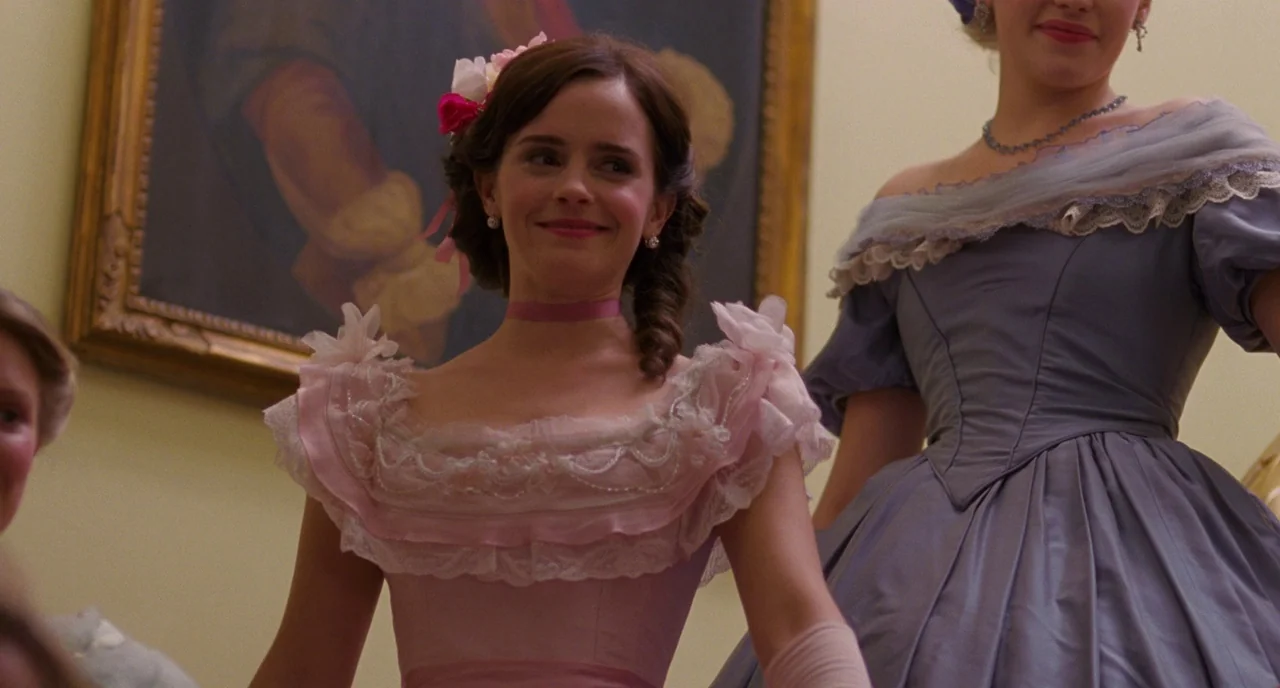 Little Women (2019) movie still: medium — An interior space features a large oil painting hanging on a light-colored wall. Two women dressed in…