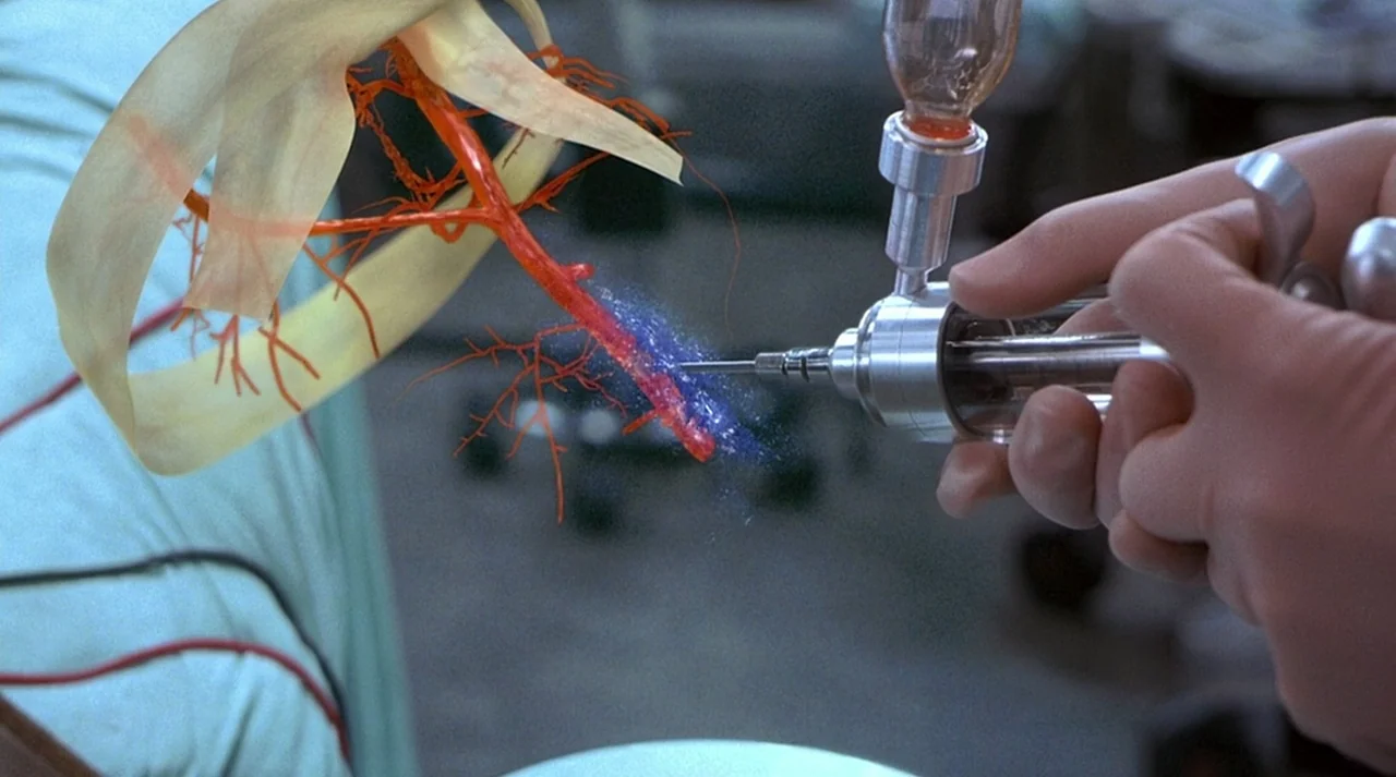 Hollow Man (2000) movie still: closeup — An anatomical model of a human artery is mounted for a scientific display. A mechanical syringe injects a…
