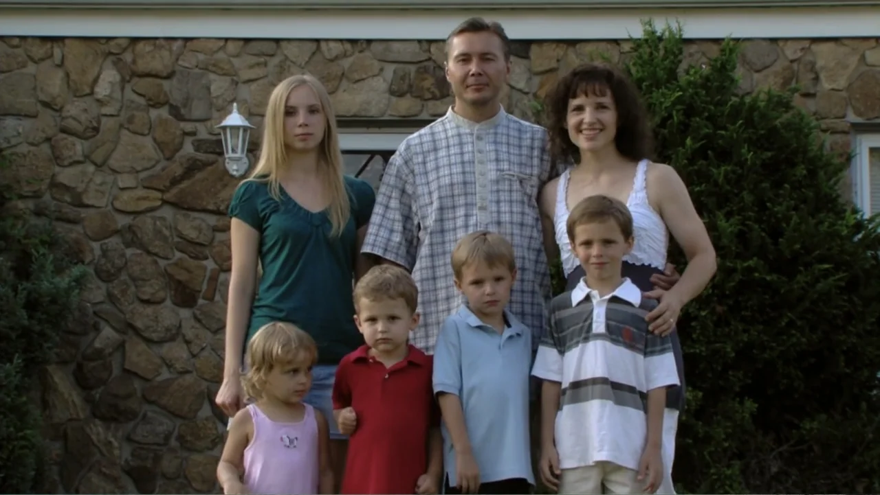 When Strangers Click: Five Stories from the Internet (2011) movie still: fullbody — A stone-clad wall with a white trim serves as the backdrop for a…