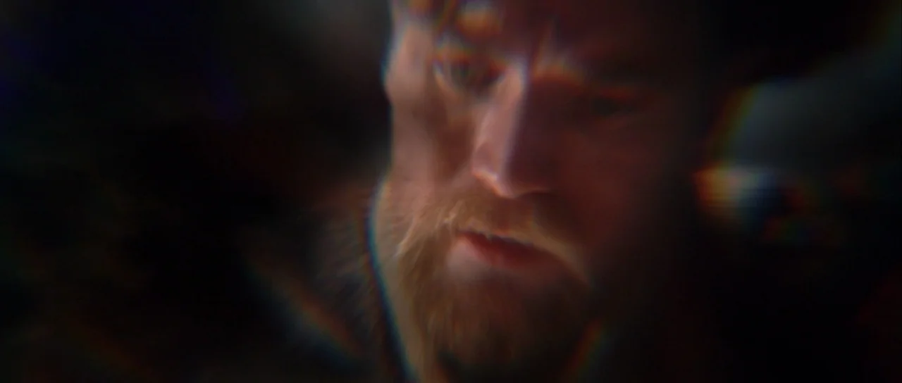 Star Wars: Episode III – Revenge of the Sith (2005) movie still: closeup — A close-up shot of a man with a beard seen through heavy optical…