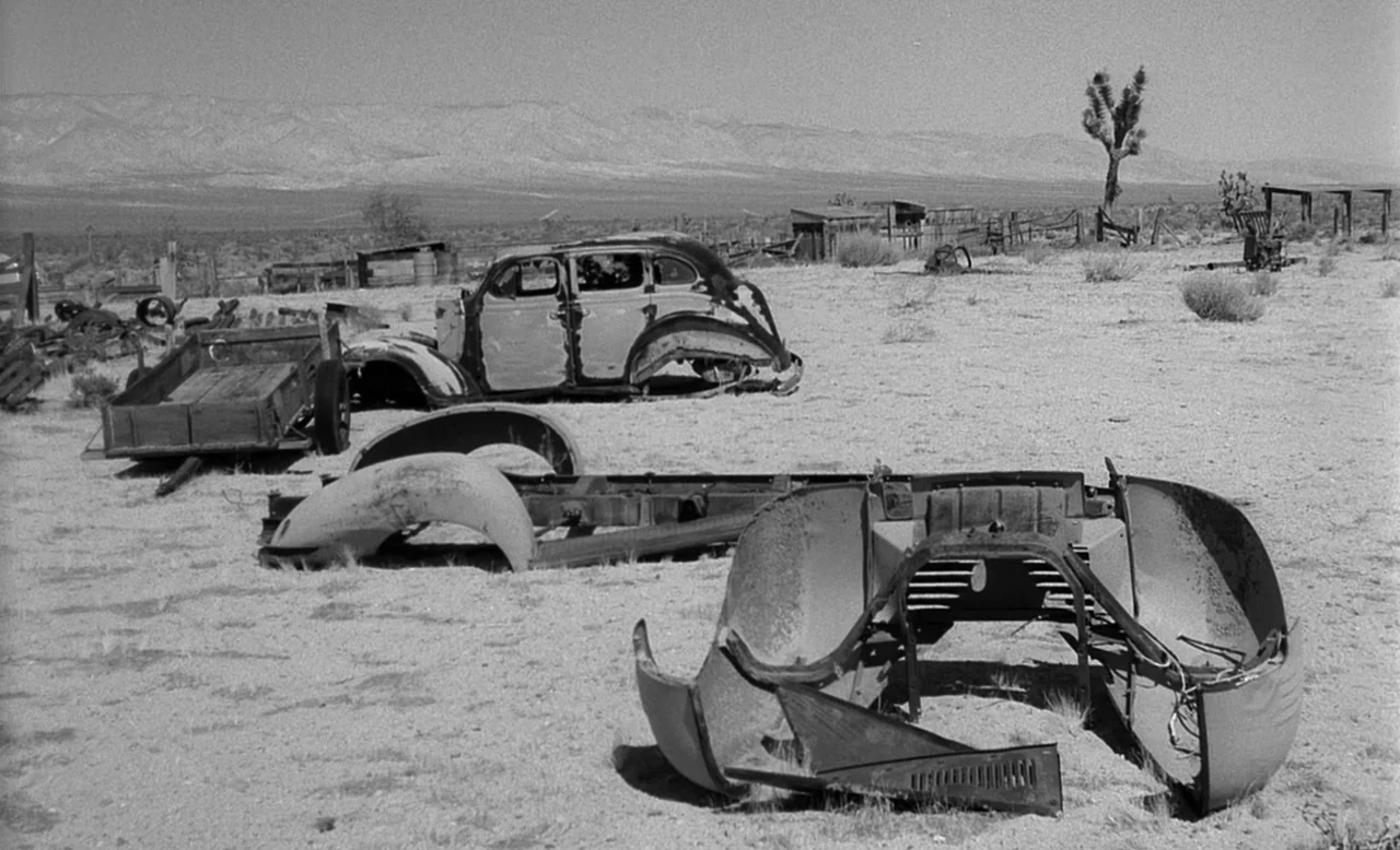 Faster, Pussycat! Kill! Kill! (1965) movie still: wide — A desolate desert landscape contains the rusted, discarded skeletons of several vintage…