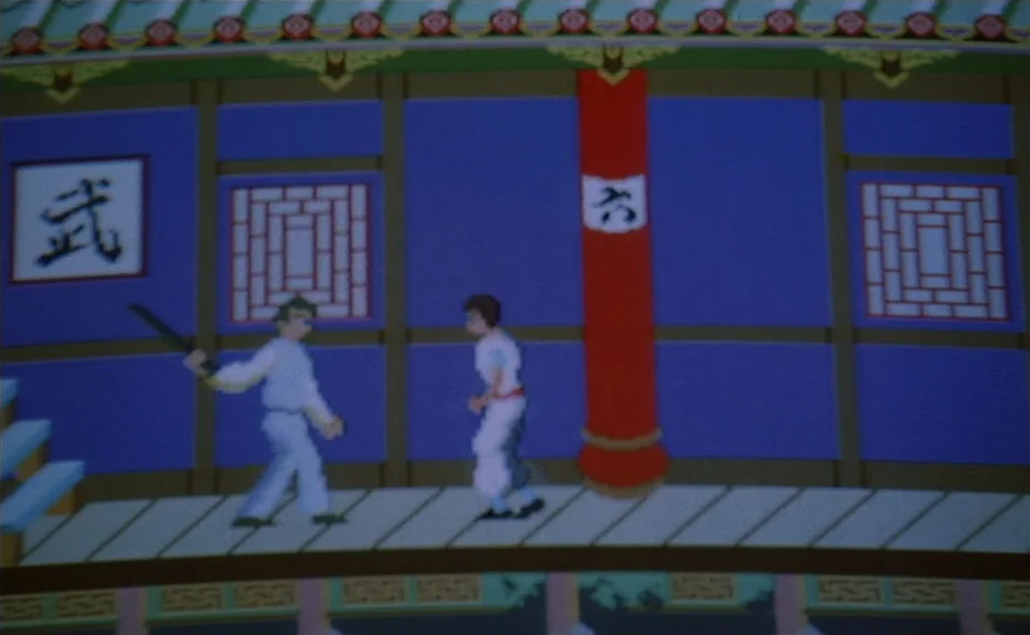 Kung Fu Master! (1988) movie still: wide — A flatly rendered 8-bit digital environment features a wooden walkway in front of walls. Two characters…
