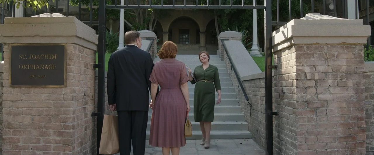 Annabelle: Creation (2017) movie still: fullbody — A gated entrance features a brass plaque identifying a brick building as an orphanage. Two…