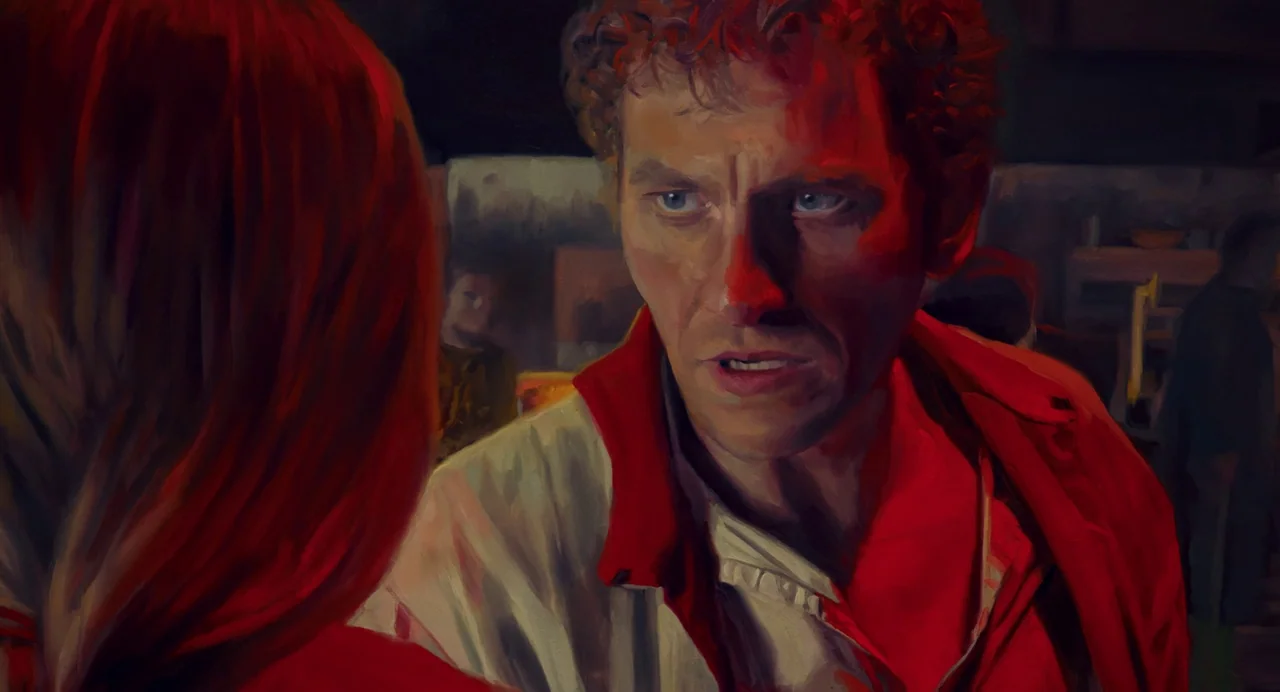 The Peasants (2023) movie still: closeup — A dimly lit room with painted-like brushstroke textures and deep shadows. A man with curly hair gazes…