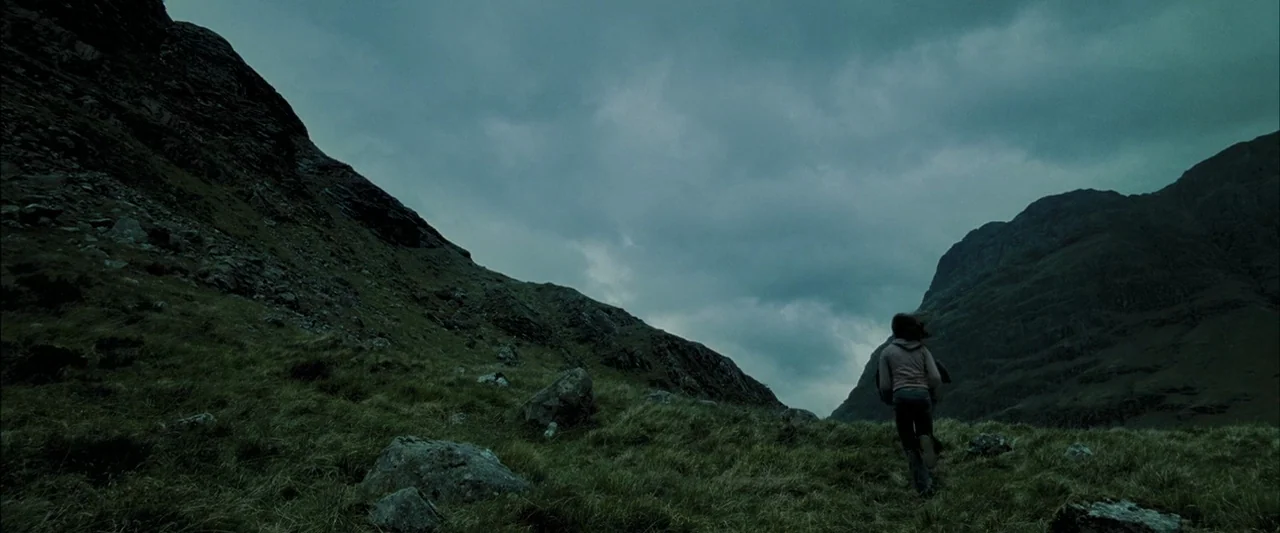 Harry Potter and the Prisoner of Azkaban (2004) movie still: wide — A desolate mountain pass features rugged slopes covered in coarse, wind-swept…