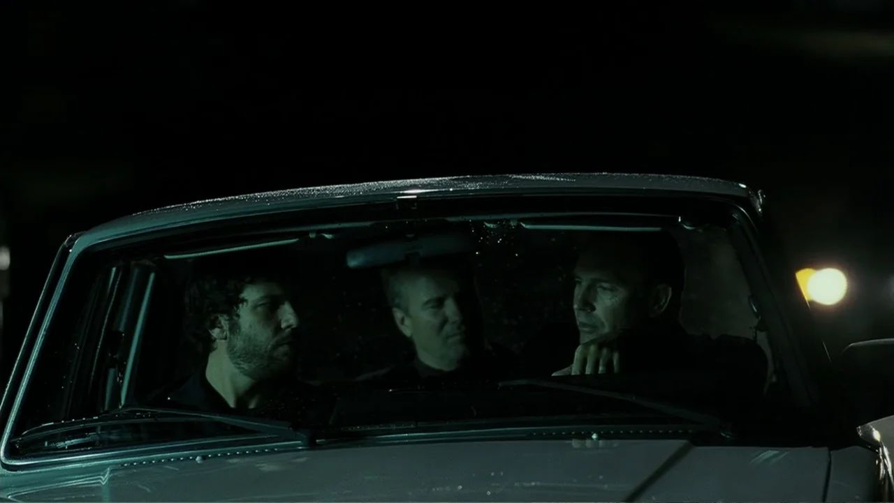 Mr. Brooks (2007) movie still: medium — Three men are sitting inside the front seats of a dark car at night. They are talking to each other while…