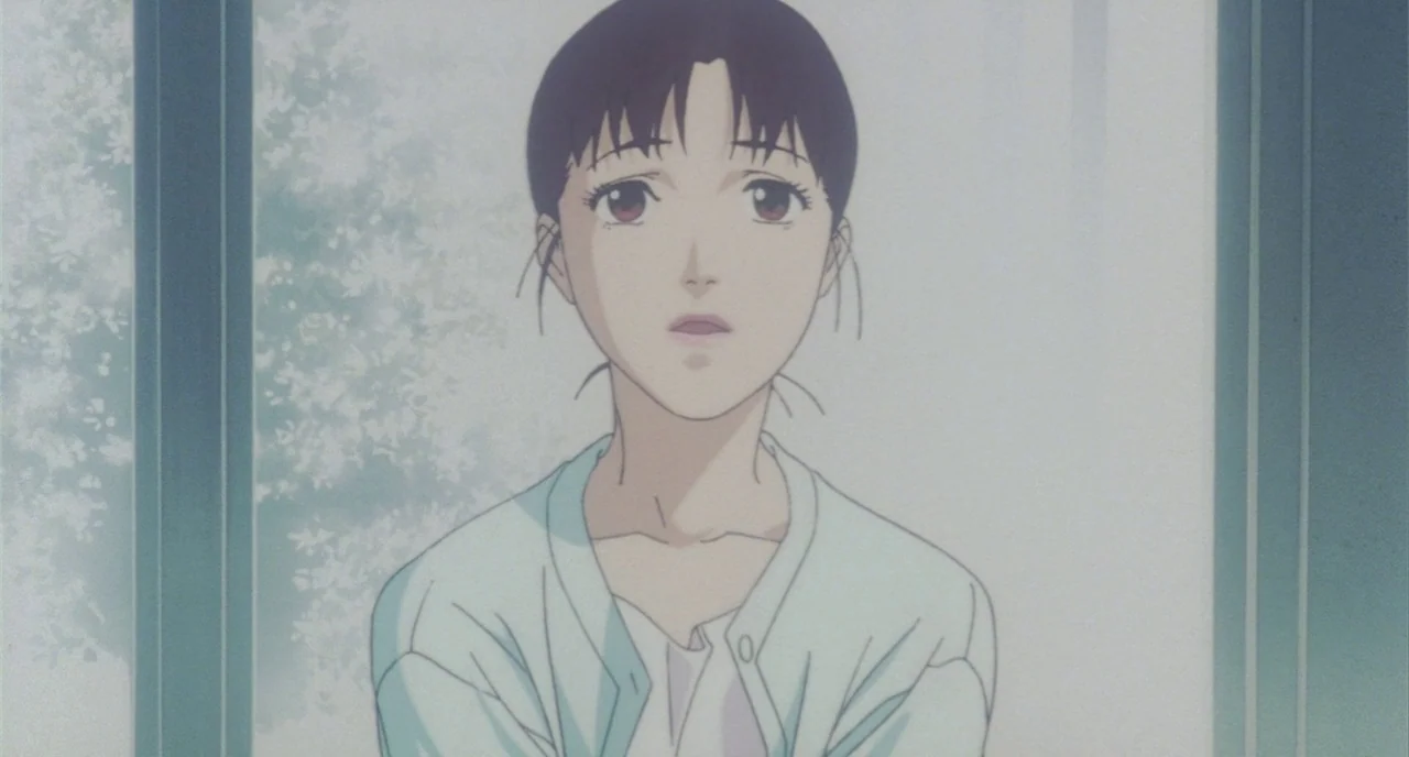 Perfect Blue (1997) movie still: medium — An interior space with a bright window behind a woman. The woman stands facing the camera with her arms…
