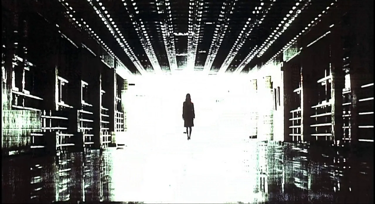 Voice (2005) movie still: wide — A dark, textured tunnel with a bright white light at the far end. A solitary female figure walks towards the viewer…