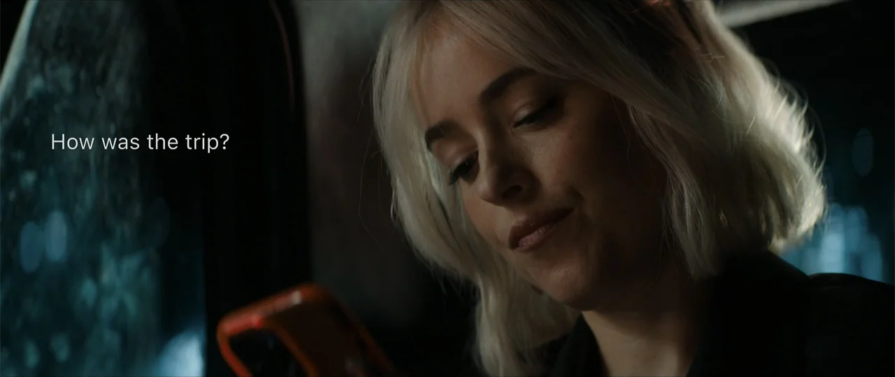 Daddio (2024) movie still: closeup — The interior of a vehicle at night with blurred dark surroundings visible through the window. A young woman…