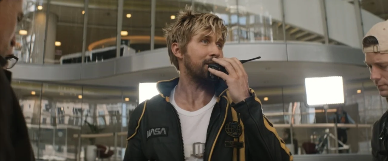 The Fall Guy (2024) movie still: medium — A spacious modern office building interior with curved glass walls and metallic architectural elements. A…