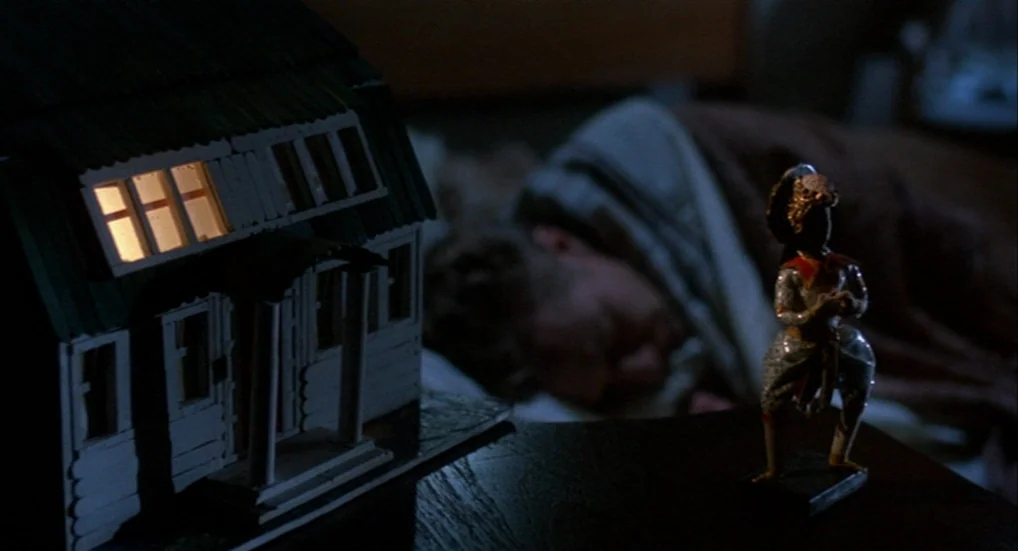 A Nightmare On Elm Street 3: Dream Warriors (1987) movie still: medium — A night bedroom scene features a wooden model house and a small decorative…
