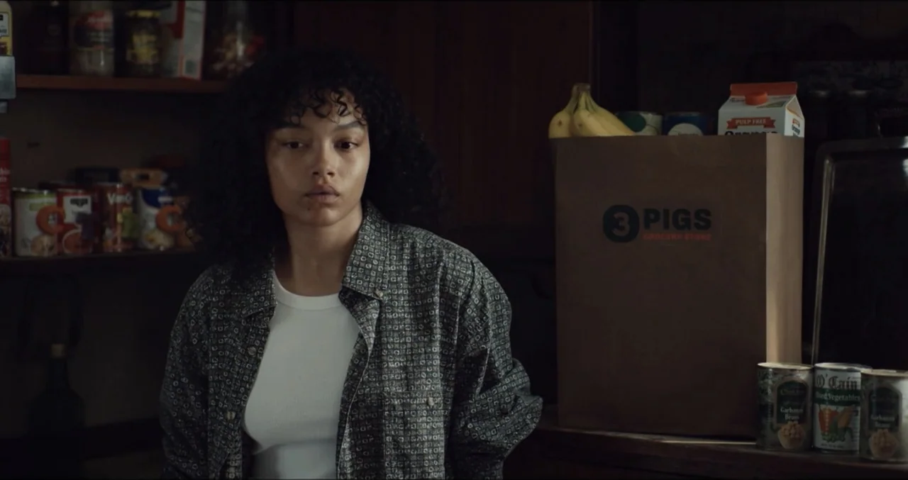 Eye for an Eye (2025) movie still: medium — A dimly lit pantry interior features shelves stocked with various canned goods and groceries. A young…