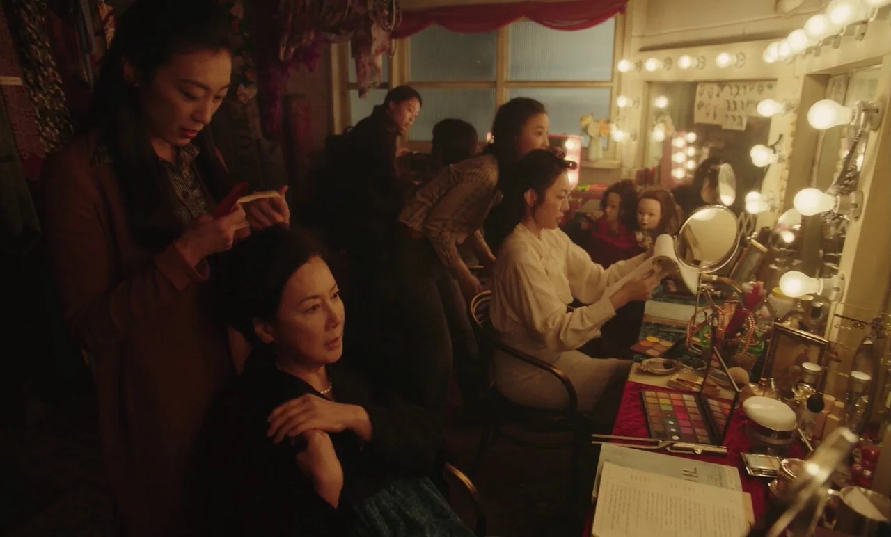 Cobweb (거미집) (2023) movie still: medium — A cluttered dressing room contains several vanity stations with illuminated bulbs and makeup kits.…