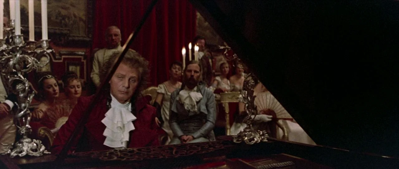 Bill and Ted’s Excellent Adventure (1989) movie still: medium — An opulent 19th-century salon features red velvet curtains and dim lighting from…