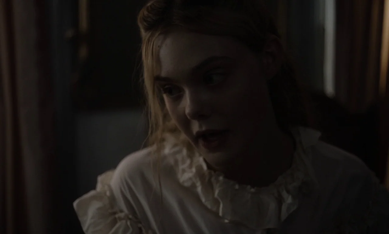 The Beguiled (2017) (2017) movie still: closeup — A dimly lit room features a young woman with a period-appropriate blouse. She looks off-camera…