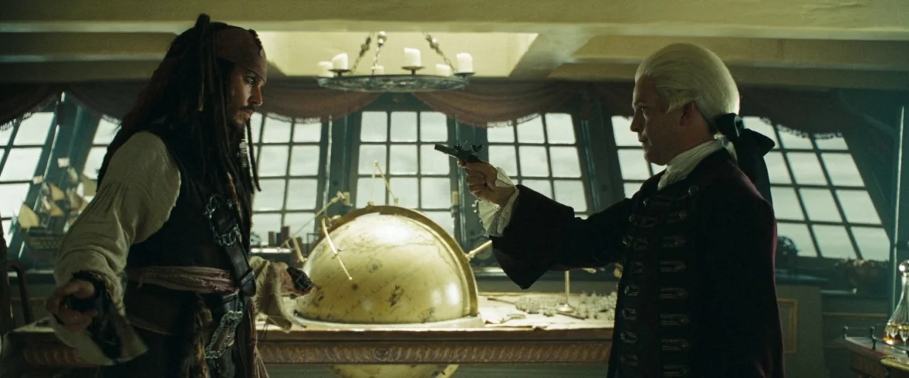 Pirates of the Caribbean: At World’s End movie still: medium — The interior of a wooden ship cabin with large rear windows and a globe. A man in a…