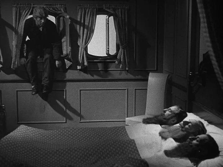 A Night at the Opera (1935) movie still: wide — A spartan ship cabin features a patterned blanket and multiple beds along one wall. A man enters…