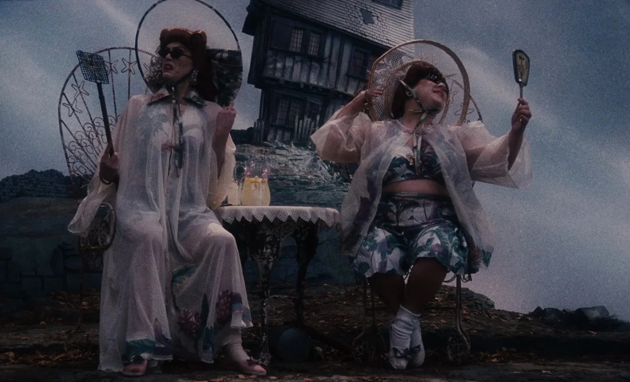 James and the Giant Peach (1996) movie still: fullbody — A desolate rocky landscape features two women sitting in front of a tilted, dilapidated…