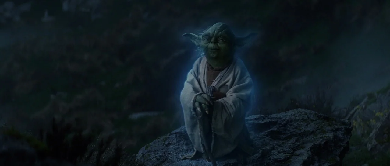 Star Wars: The Last Jedi (2017) movie still: medium — A dark, misty cliffside at night with rocky terrain visible in the background. The small green…