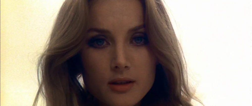Don’t Torture A Duckling (1972) movie still: closeup — A close portrait shot focused on a woman's face against a bright background. The subject…